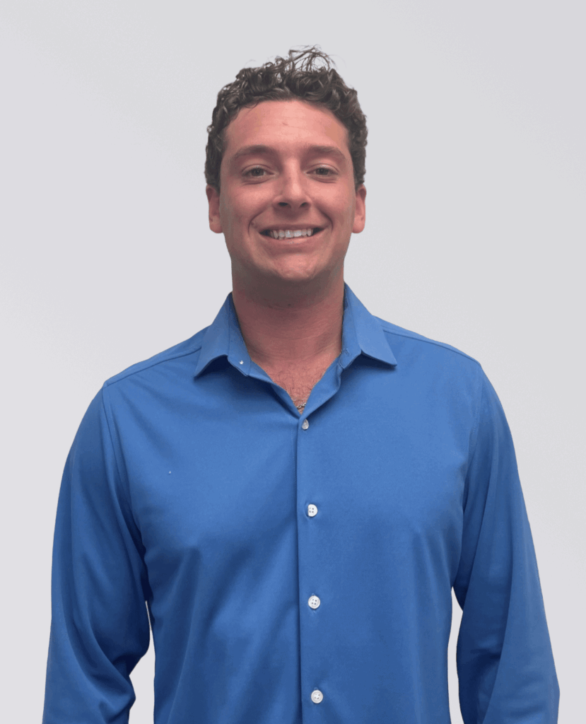 Professional headshot of a smiling man in a blue shirt