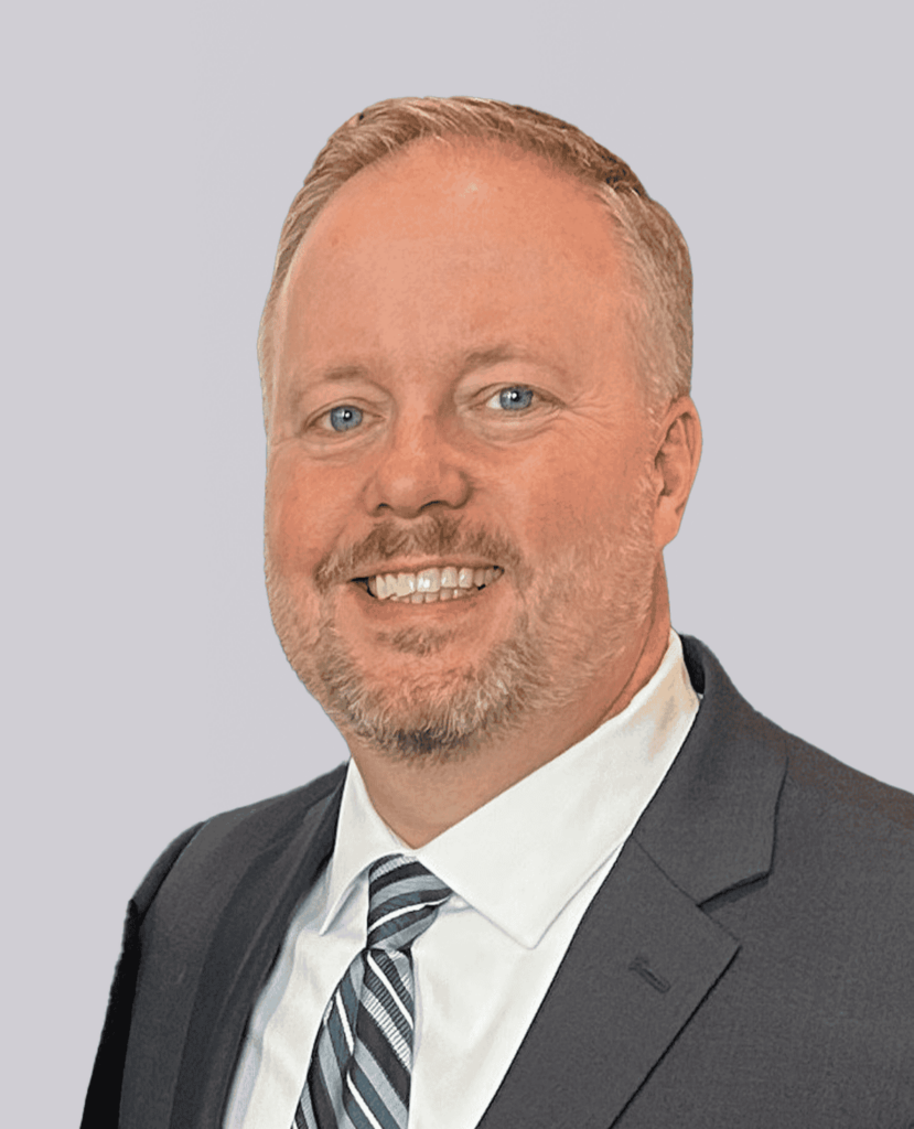 Professional Headshot of a smiling man in a gray suit